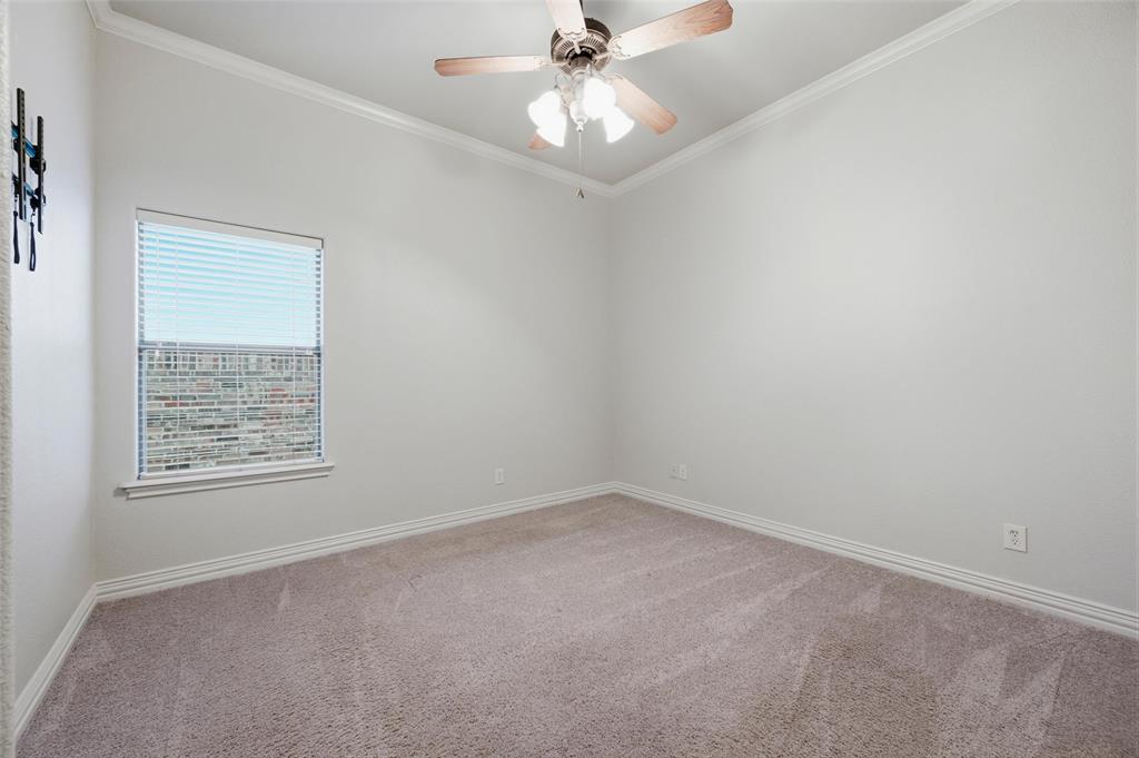 620 Highview Lane Hurst, TX 76054 - Photo 30 of 40 Neutral-toned room featuring a single window with blinds, carpet flooring, a ceiling fan, crown molding, and baseboards
