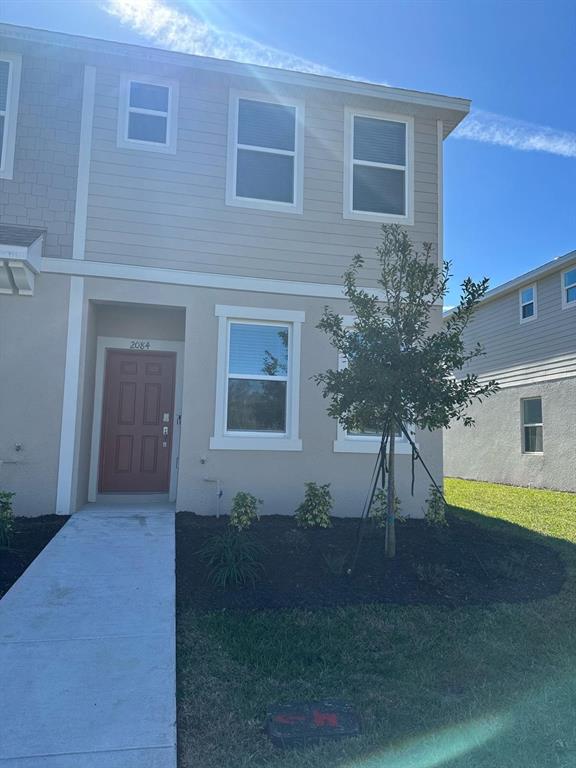 2084 Viewfinder Street Kissimmee, FL 34758 - Photo 1 of 18 a front view of a house with a yard