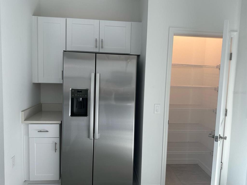 2084 Viewfinder Street Kissimmee, FL 34758 - Photo 6 of 18 a kitchen with a refrigerator and a sink