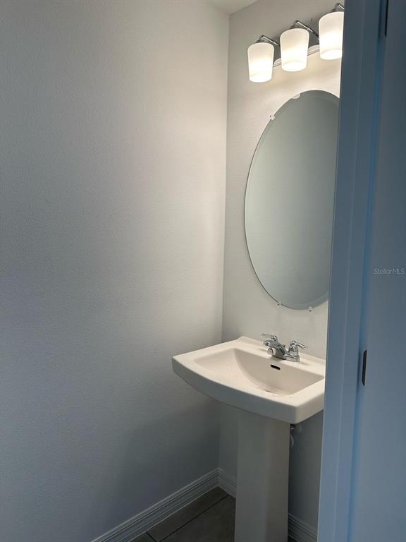 2084 Viewfinder Street Kissimmee, FL 34758 - Photo 8 of 18 a bathroom with a sink and a mirror