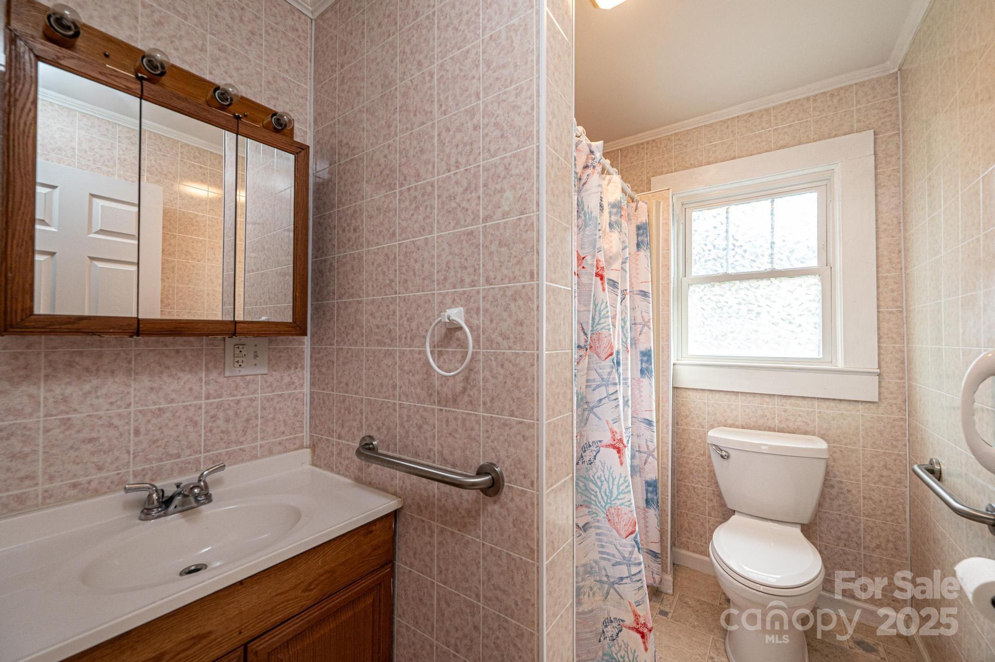 55 Duke Street Granite Falls, NC 28630 - Photo 17 of 45 a bathroom with a sink a toilet and a mirror