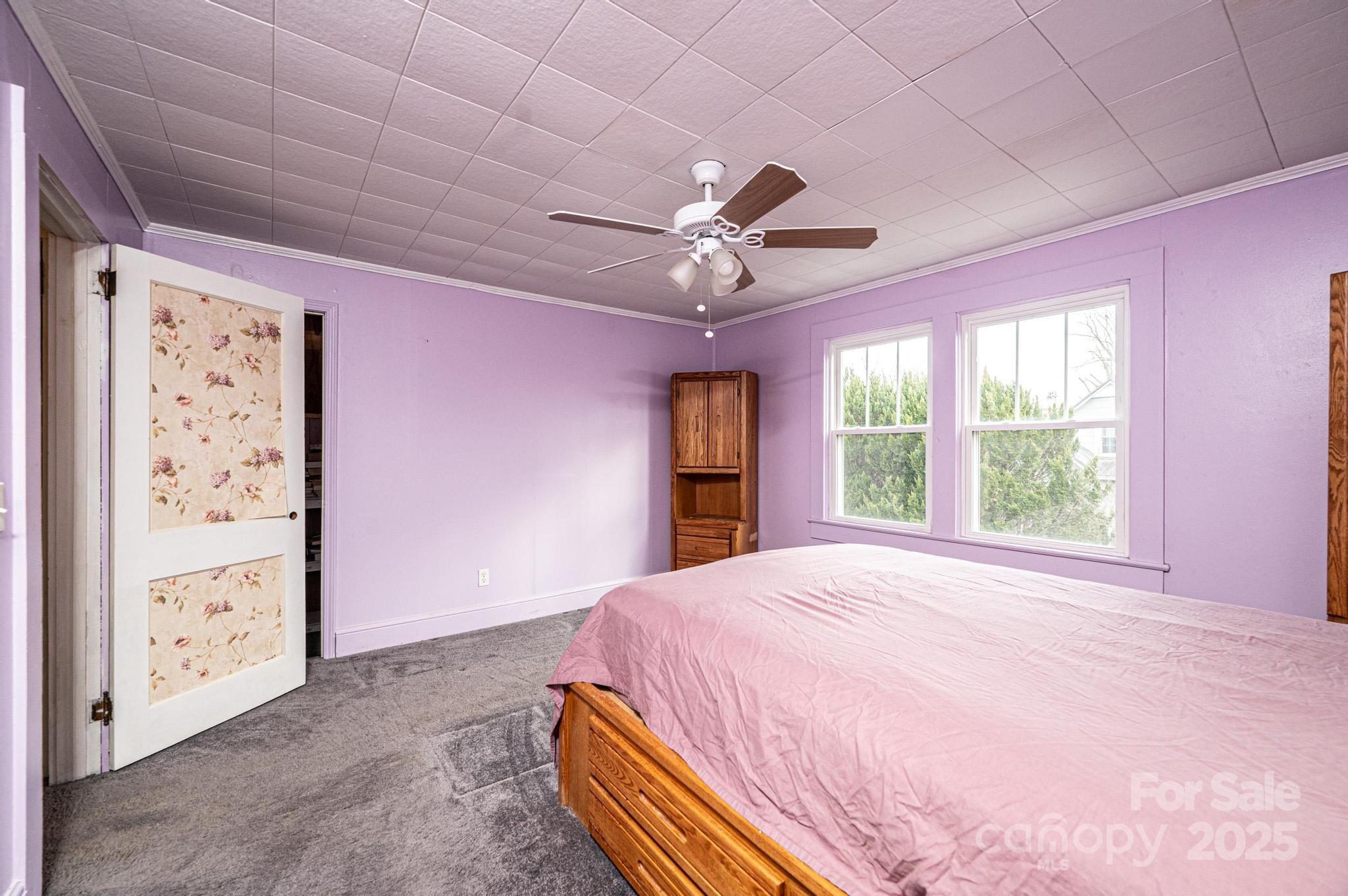 55 Duke Street Granite Falls, NC 28630 - Photo 21 of 45 a bed room with a bed and a ceiling fan