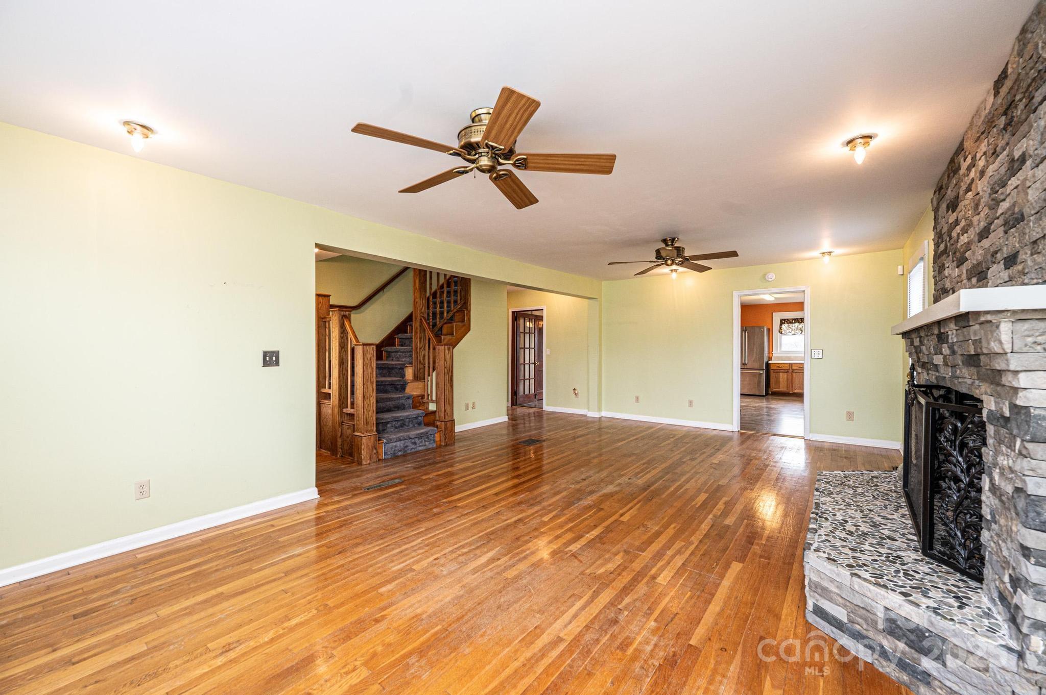 55 Duke Street Granite Falls, NC 28630 - Photo 8 of 45 a view of empty room with wooden floor and fireplace