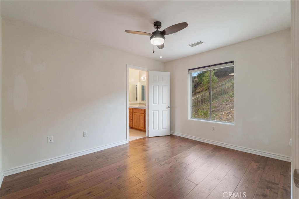 1259 Gonzales Road Simi Valley, CA 93063 - Photo 12 of 39 an empty room with wooden floor and windows