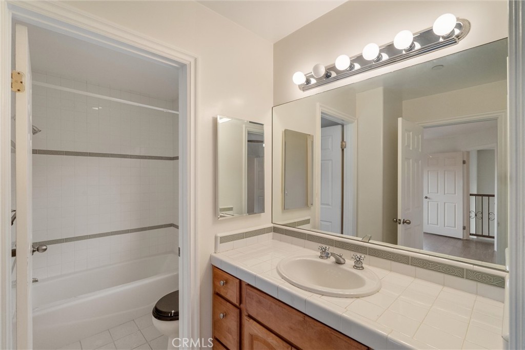 1259 Gonzales Road Simi Valley, CA 93063 - Photo 13 of 39 a bathroom with a sink tub and a mirror