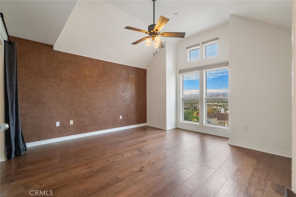 1259 Gonzales Road Simi Valley, CA 93063 - Photo 17 of 39 a view of an empty room with wooden floor and a window