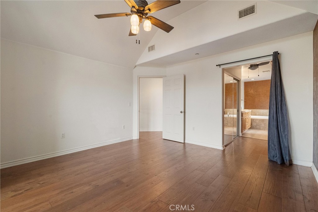 1259 Gonzales Road Simi Valley, CA 93063 - Photo 18 of 39 an empty room with wooden floor fan and windows