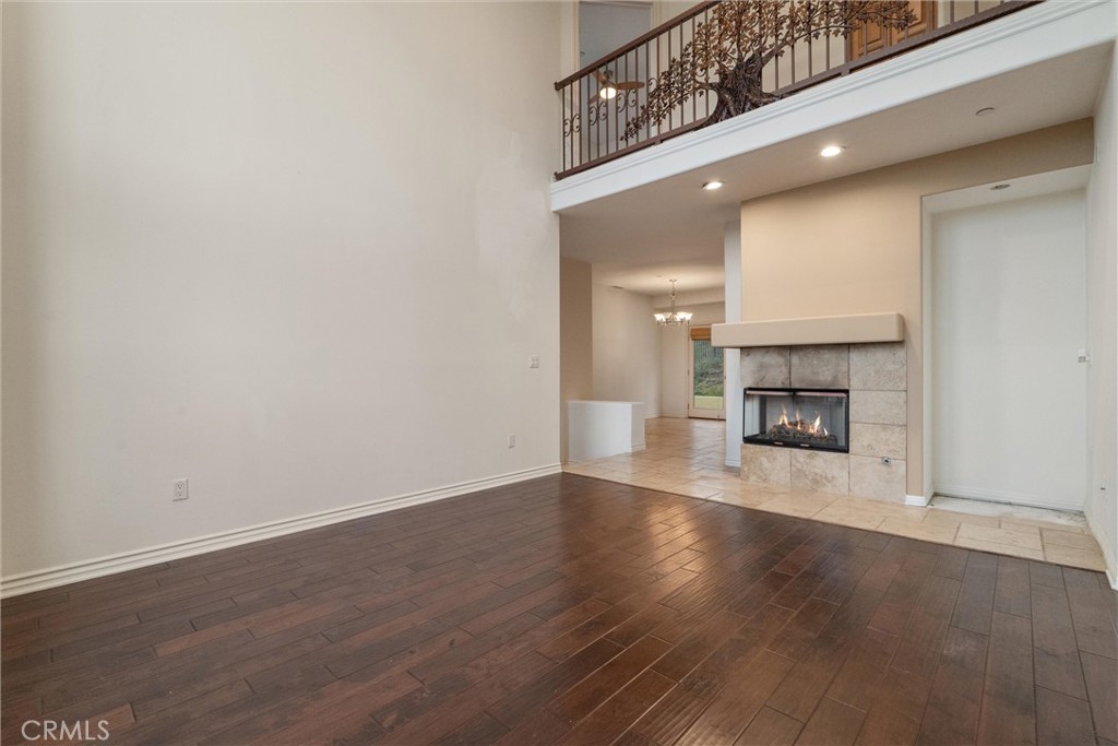 1259 Gonzales Road Simi Valley, CA 93063 - Photo 27 of 39 a view of a livingroom with wooden floor and a fireplace