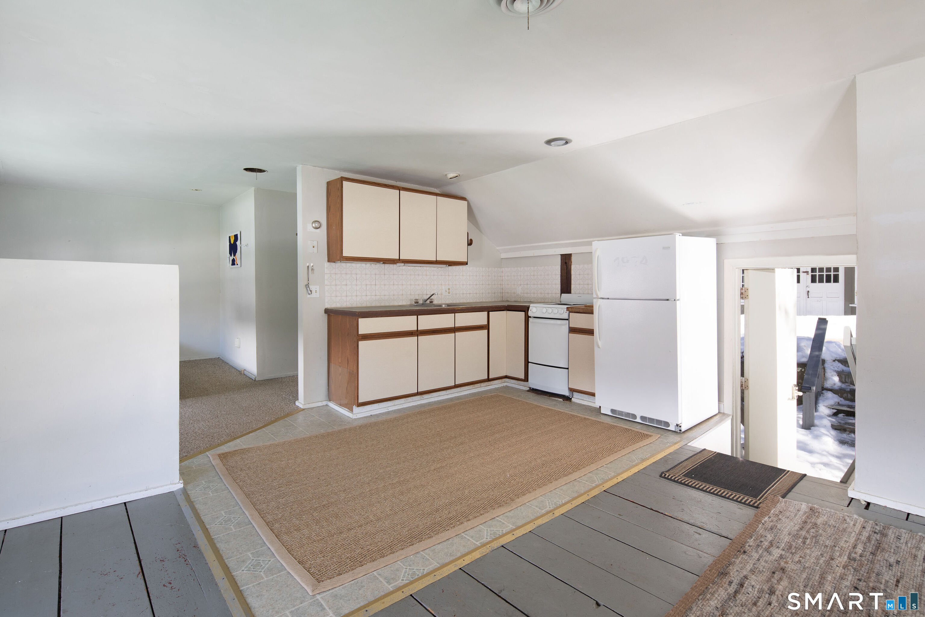 7 Railroad Street Cornwall, CT 06796 - Photo 2 of 8 a view of a kitchen with wooden floor electronic appliances and a window