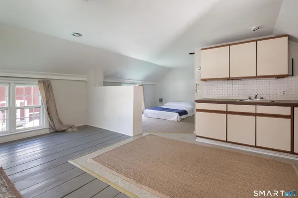 a spacious bedroom with a bed and a cabinets