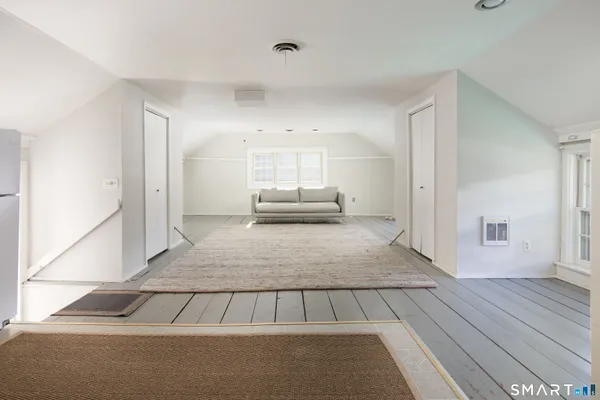 a living room with a couch and a rug