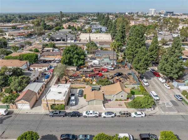 an aerial view of residential houses with city view
