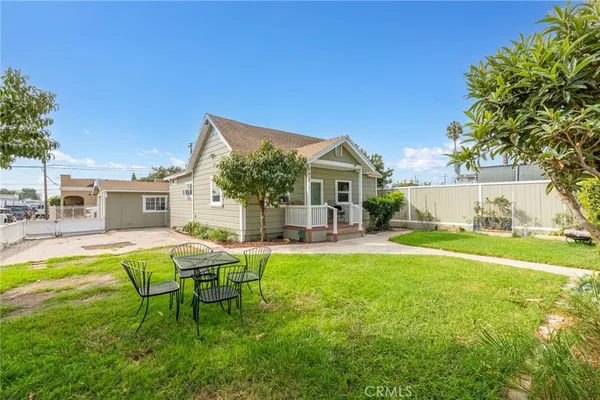 a view of a house with a yard and sitting area