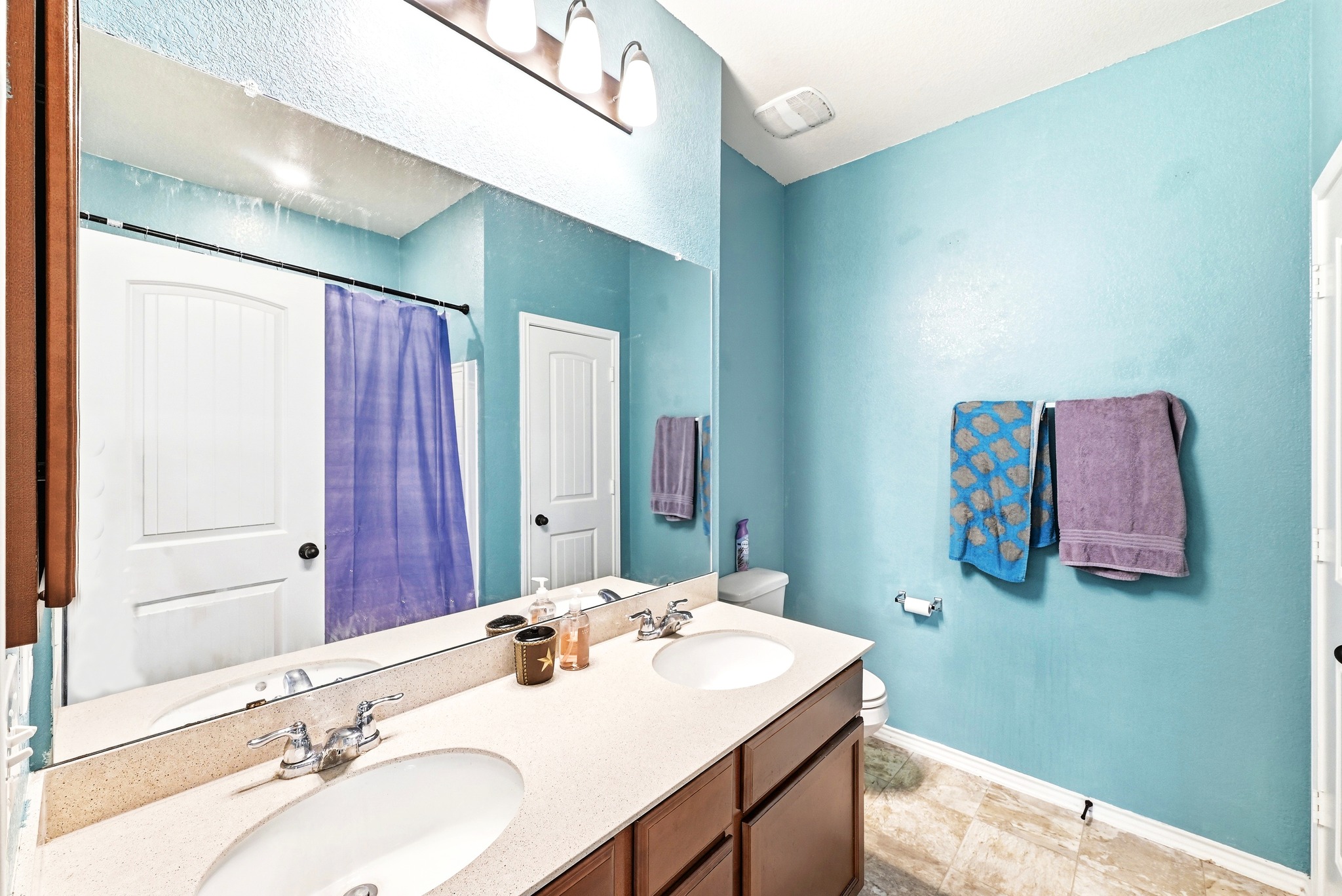 1621 Dragonfly Loop Bastrop, TX 78602 - Photo 18 of 27 Double vanity with undermount sinks, chrome fixtures, and a light-colored countertop