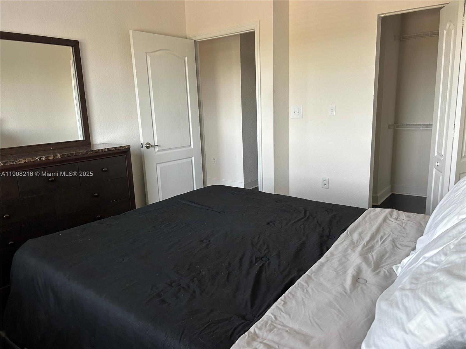 6001 Southwest 70th Street, Unit 551 South Miami, FL 33143 - Photo 11 of 23 a bedroom with a bed next to a window