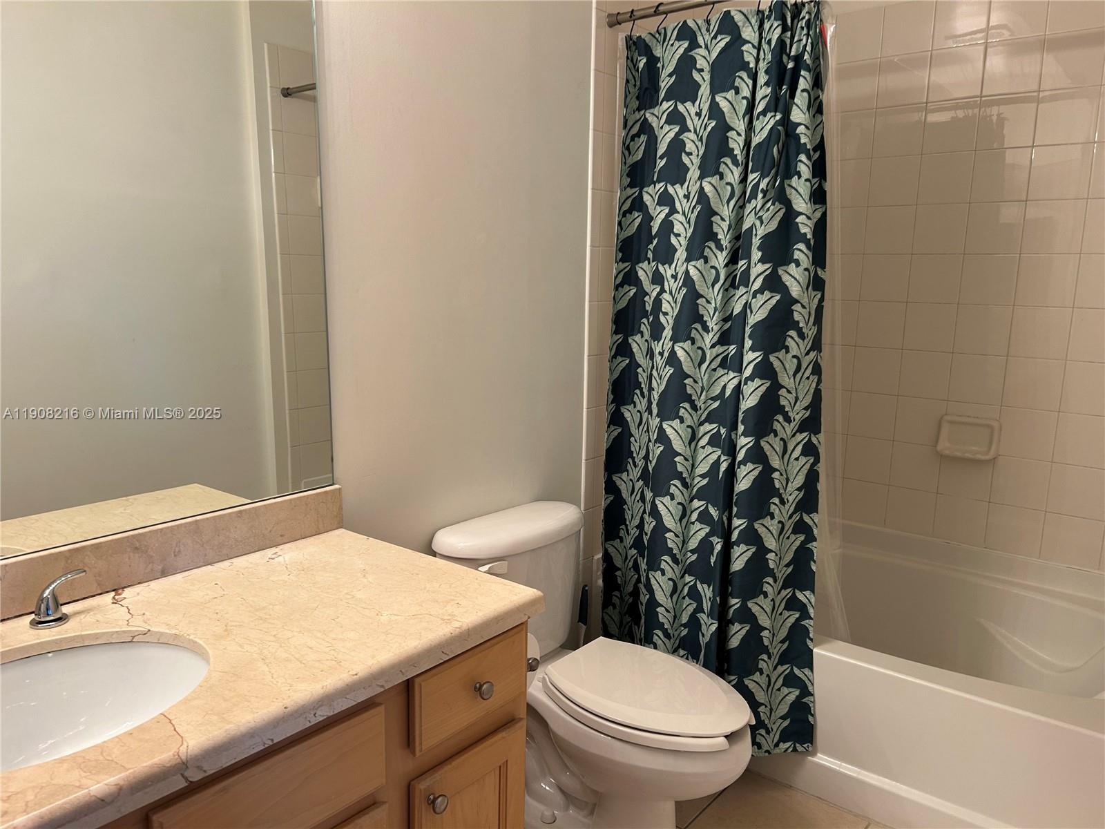 6001 Southwest 70th Street, Unit 551 South Miami, FL 33143 - Photo 14 of 23 a bathroom with a granite countertop sink toilet and shower