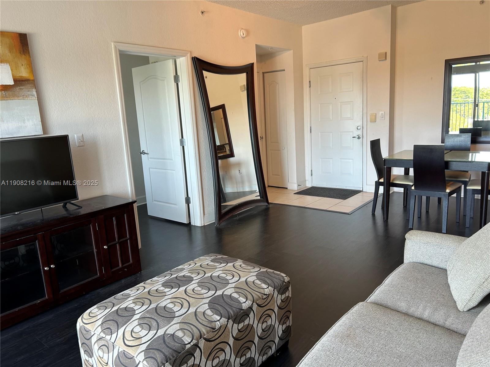 6001 Southwest 70th Street, Unit 551 South Miami, FL 33143 - Photo 15 of 23 a view of a livingroom with furniture and wooden floor