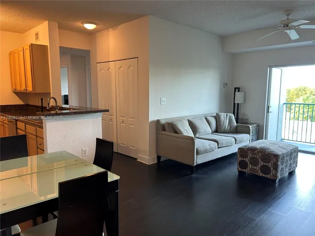 a living room with furniture wooden floor and a table