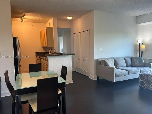 a living room with furniture wooden floor and a flat screen tv