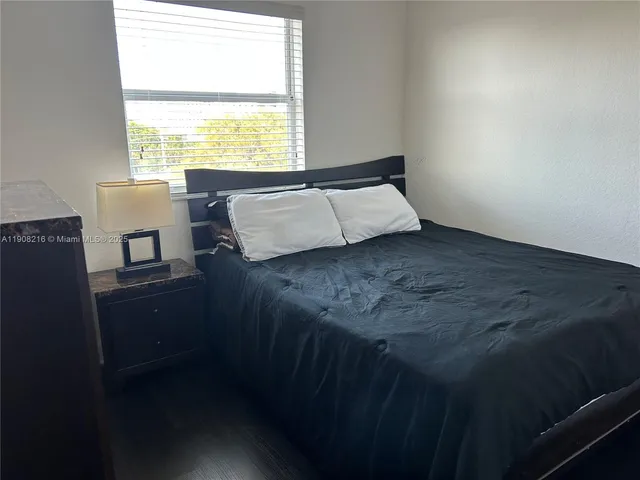a bed sitting in a bedroom next to a window