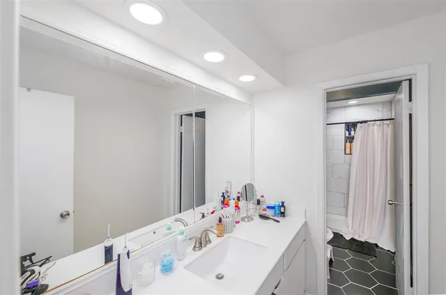 a bathroom with a sink vanity and a mirror
