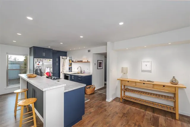 a room with furniture and a view of kitchen
