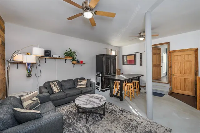a living room with furniture a rug and a window