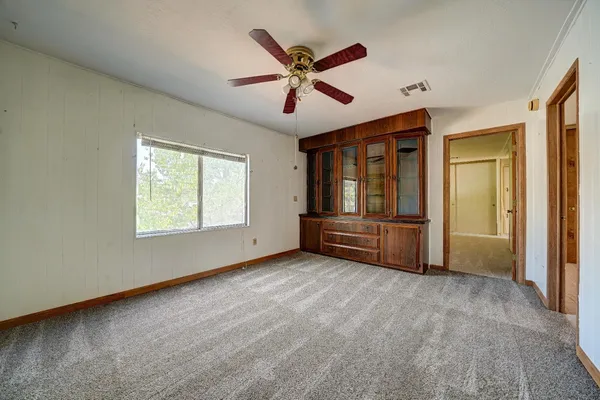 a spacious bathroom with a granite countertop sink mirror and a