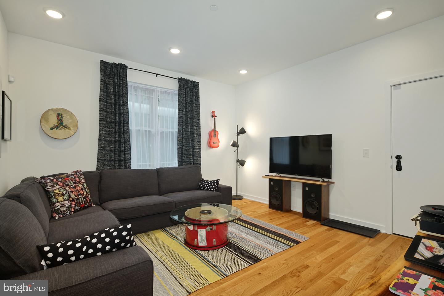 1917 East Letterly Street, Unit F Philadelphia, PA 19125 - Photo 4 of 19 a living room with furniture and a flat screen tv