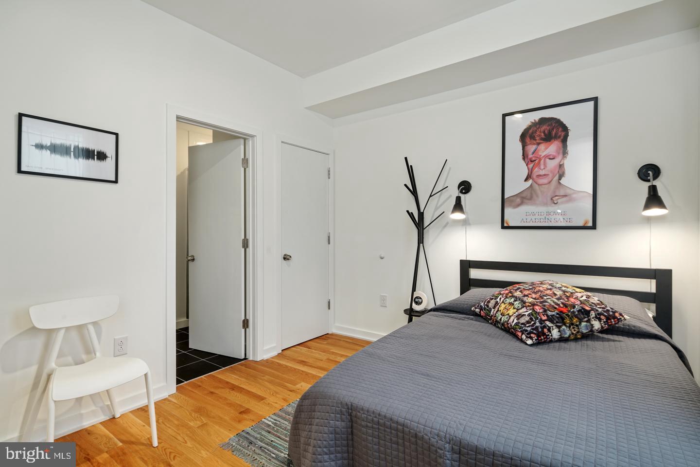 1917 East Letterly Street, Unit F Philadelphia, PA 19125 - Photo 7 of 19 a bedroom with a bed and a painting on the wall