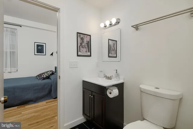 a bathroom with a toilet sink and mirror