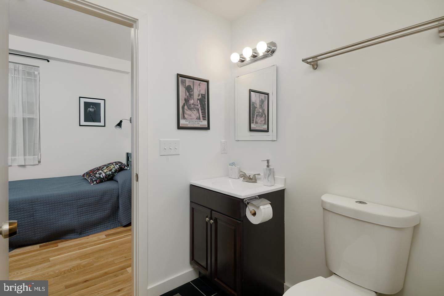 1917 East Letterly Street, Unit F Philadelphia, PA 19125 - Photo 8 of 19 a bathroom with a toilet sink and mirror