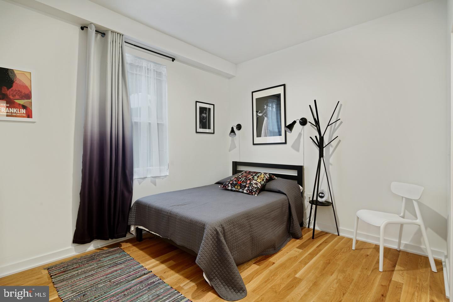 1917 East Letterly Street, Unit F Philadelphia, PA 19125 - Photo 9 of 19 a bedroom with a bed and a window