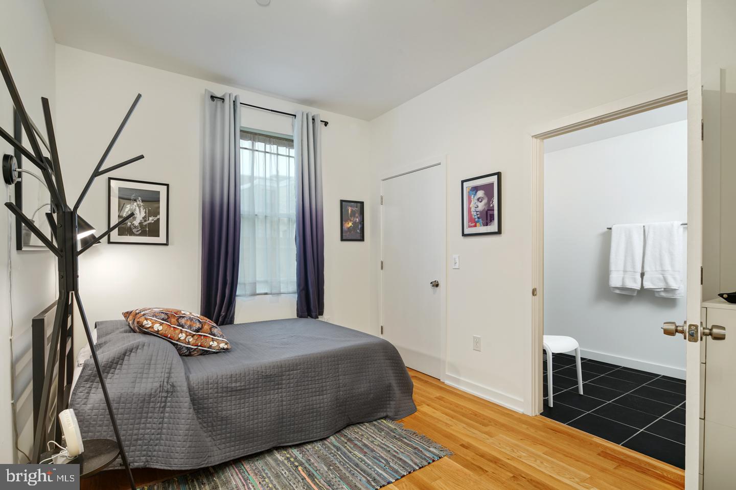 1917 East Letterly Street, Unit F Philadelphia, PA 19125 - Photo 10 of 19 a bedroom with a bed and wooden floor