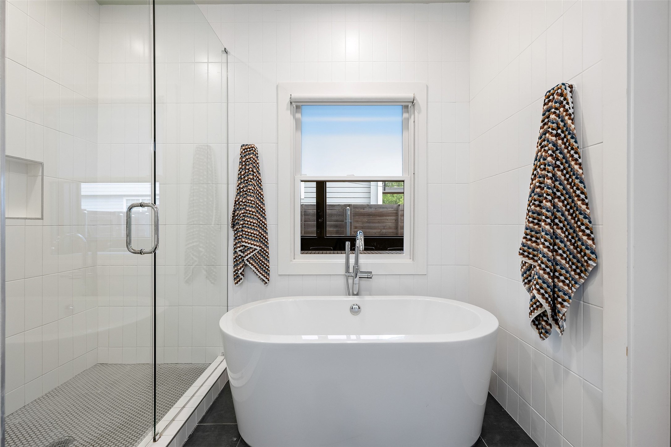 2000 Rundell Place Austin, TX 78704 - Photo 24 of 38 Luxurious bathroom offering a standalone soaking tub and a spacious glass-enclosed shower.