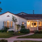 a front view of house with a garden