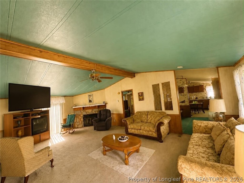 4435 Tartt's Mill Road Wilson, NC 27893 - Photo 4 of 23 a living room with furniture and a flat screen tv