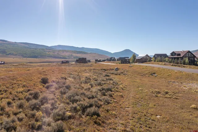 a view of a town with mountains in the background