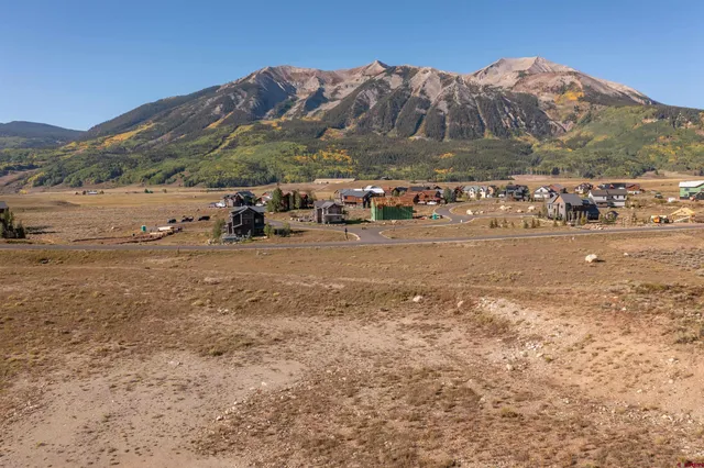 a view of a town with mountains in the background