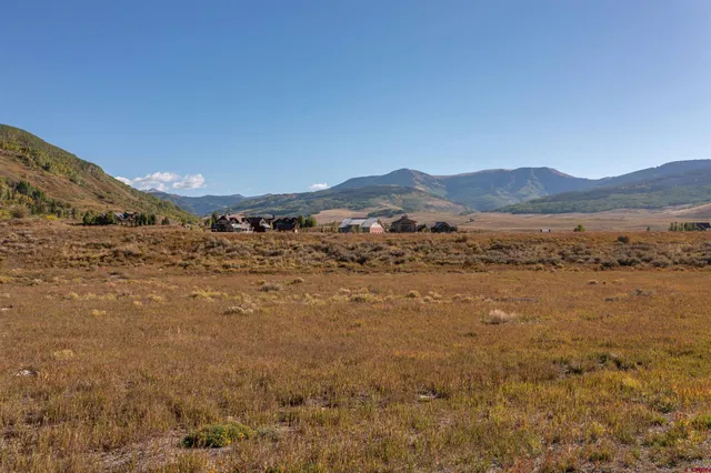 a view of mountain with sunset in background