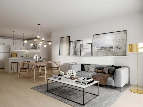 a living room with furniture kitchen view and a chandelier