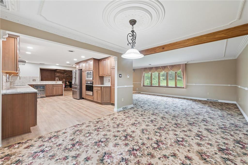 22 Buzzardtown Road Irwin, PA 15642 - Photo 12 of 44 a view of a kitchen with a refrigerator wooden floor and a kitchen space