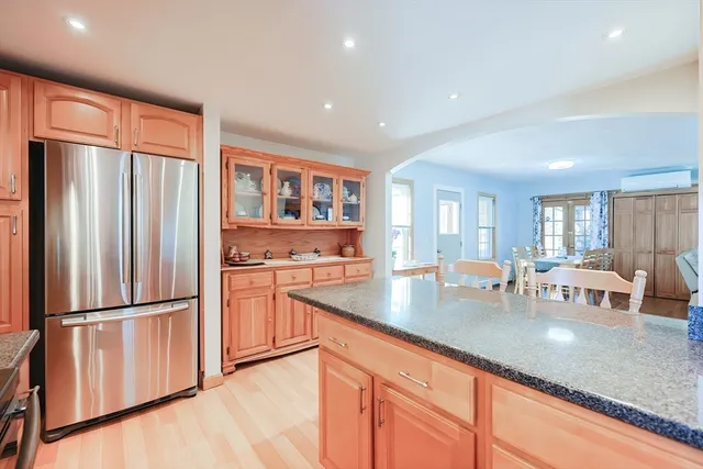a view of a livingroom with wooden floor and a fireplace