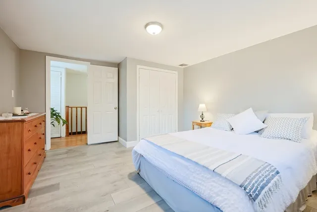 a bed sitting in a bedroom next to a window