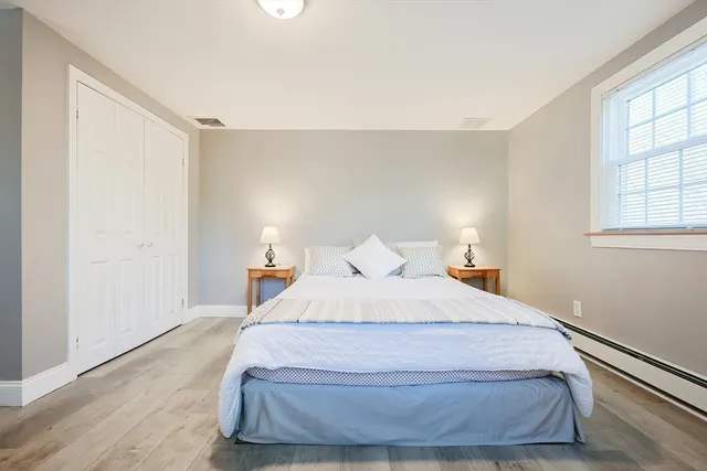 a bedroom with a bed and a dresser in it