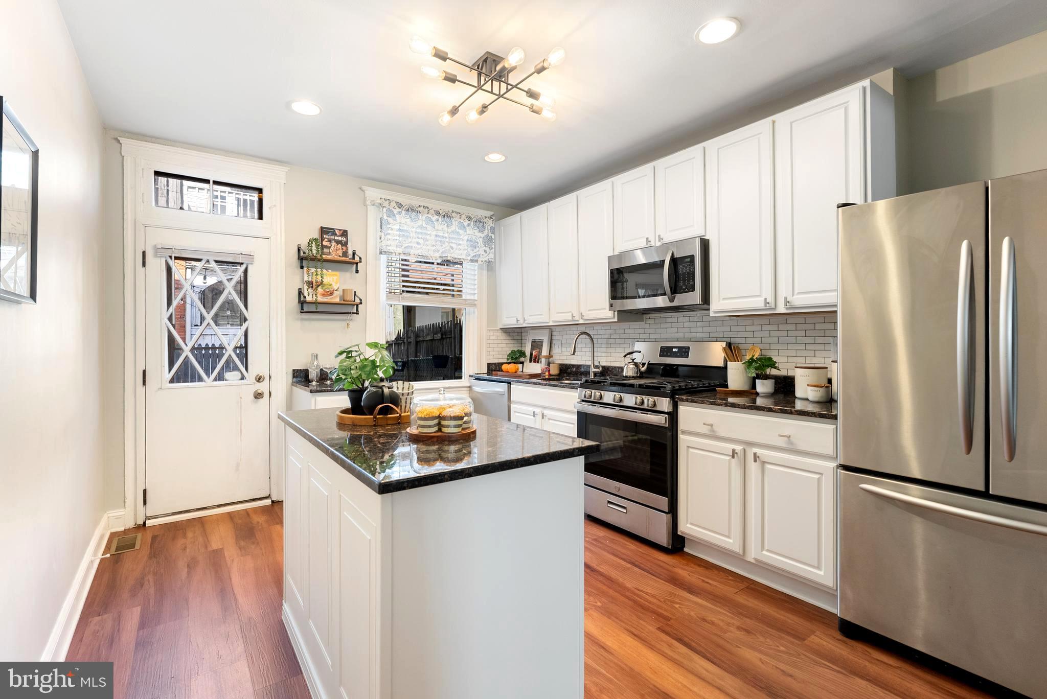 280 South Robinson Street Baltimore, MD 21224 - Photo 13 of 40 a kitchen with stainless steel appliances a refrigerator sink and microwave