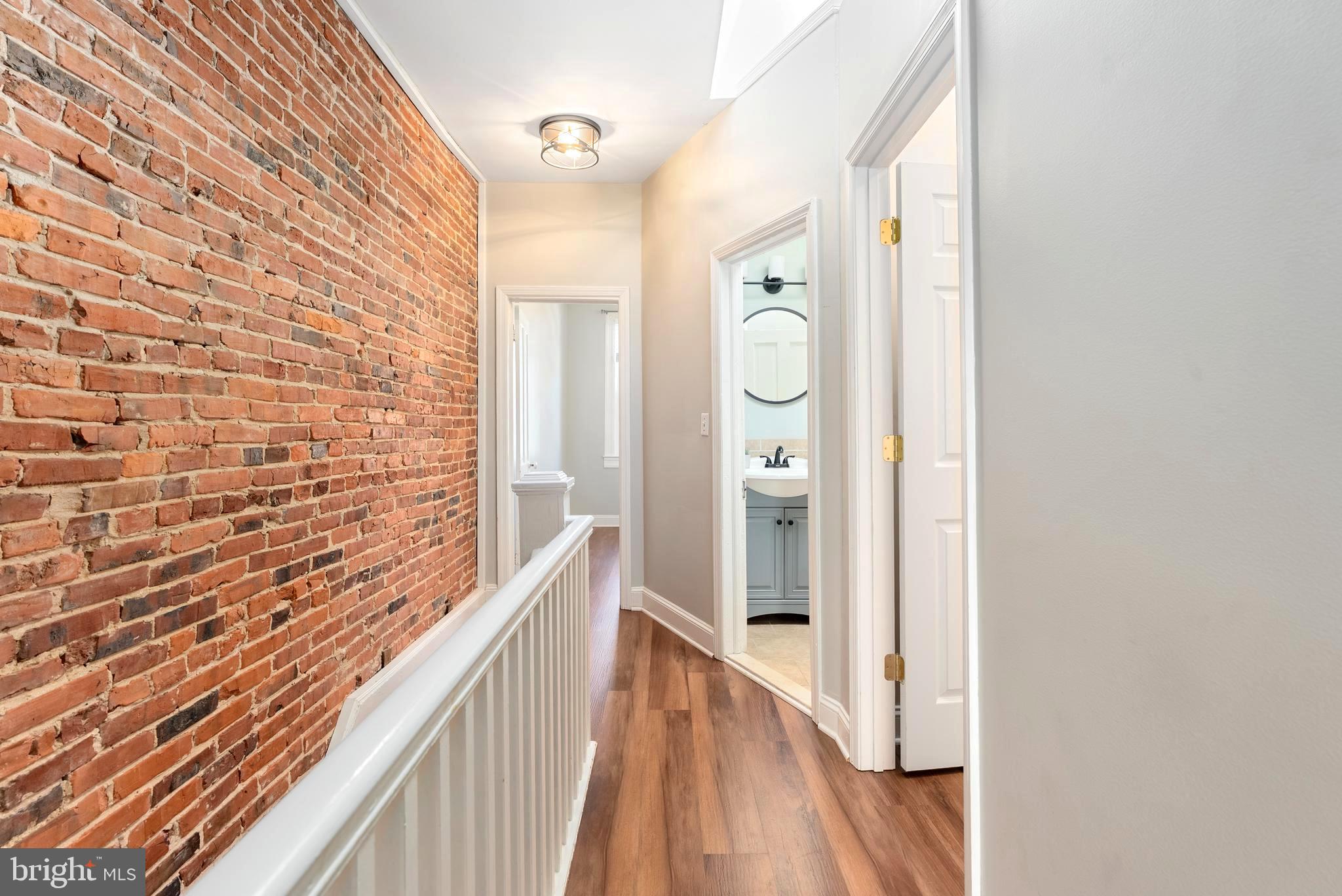 280 South Robinson Street Baltimore, MD 21224 - Photo 18 of 40 a view of a hallway with wooden floor and staircase