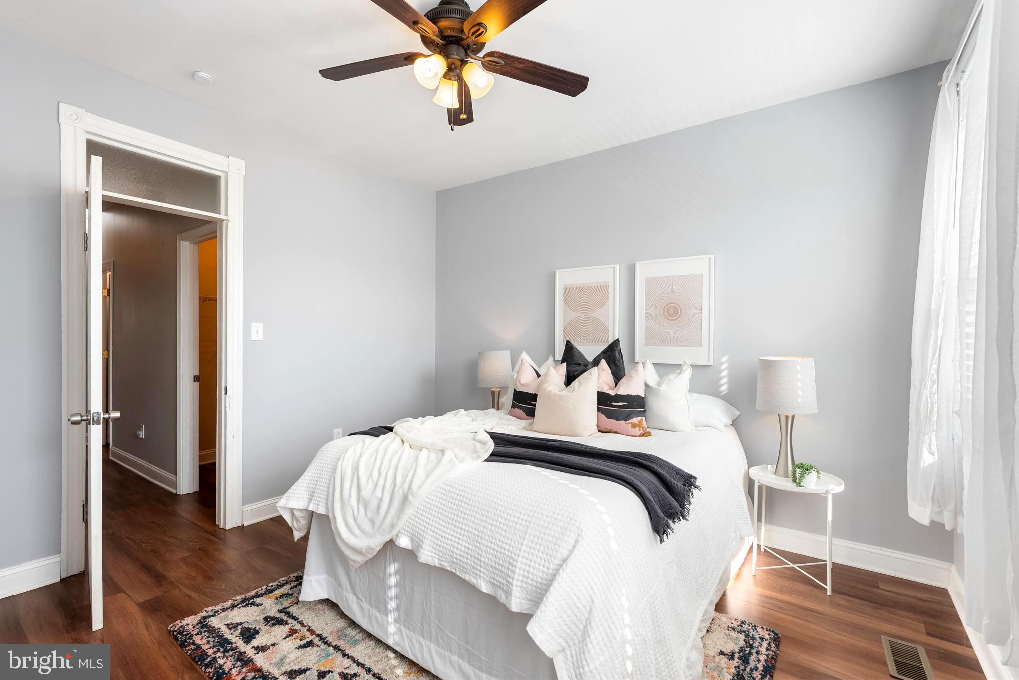 280 South Robinson Street Baltimore, MD 21224 - Photo 21 of 40 a bedroom with a bed and wooden floor