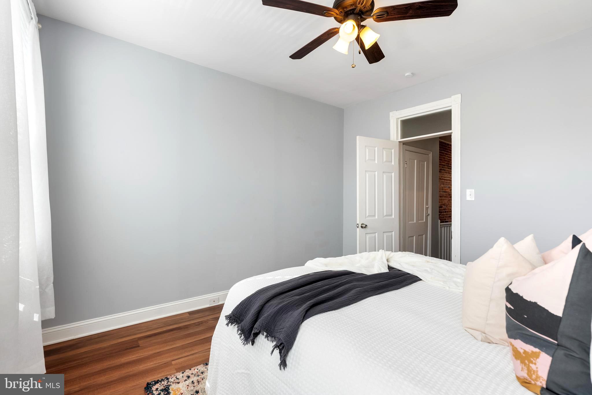 280 South Robinson Street Baltimore, MD 21224 - Photo 22 of 40 a bedroom with a bed and cabinets