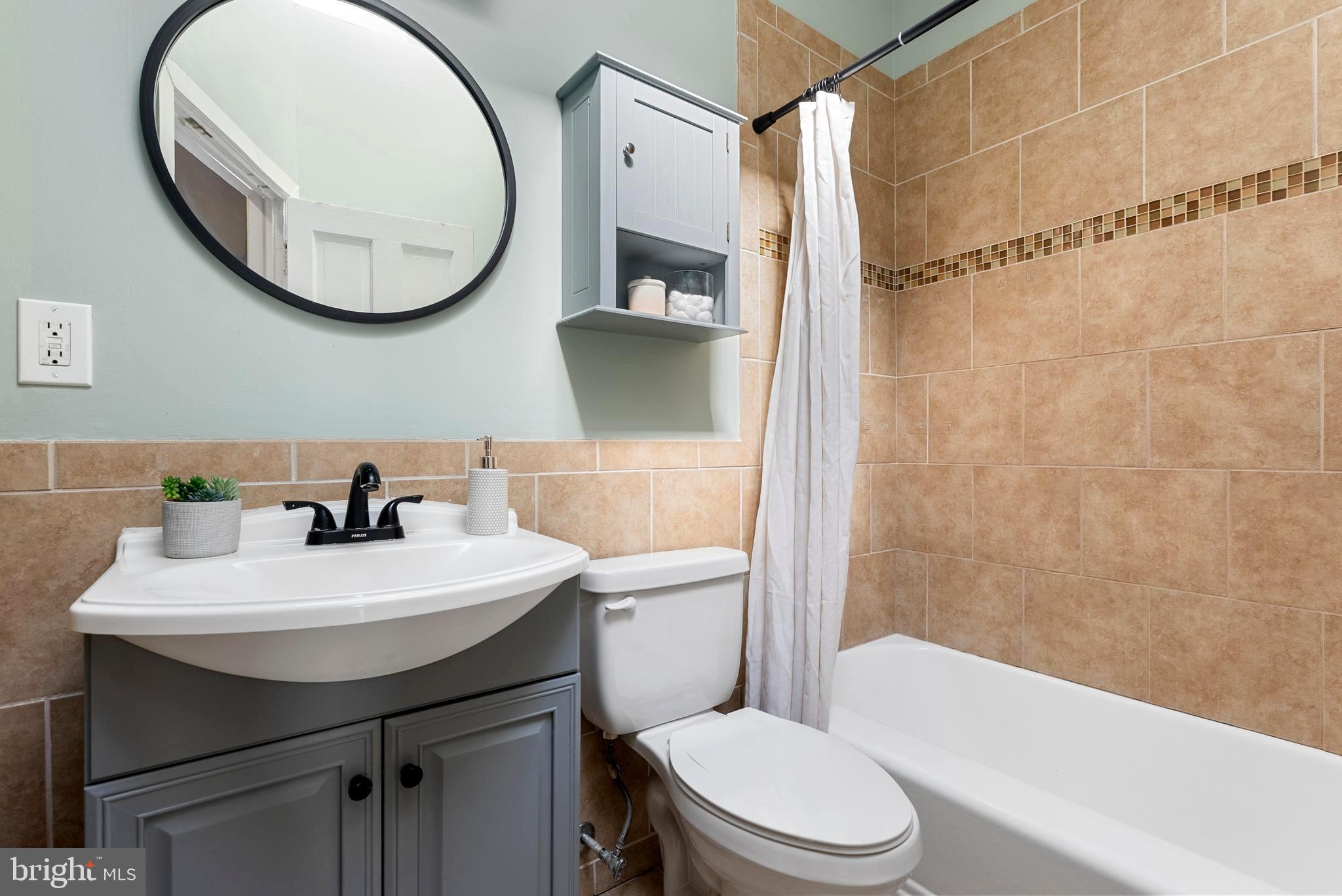 280 South Robinson Street Baltimore, MD 21224 - Photo 25 of 40 a bathroom with a sink a toilet and a mirror
